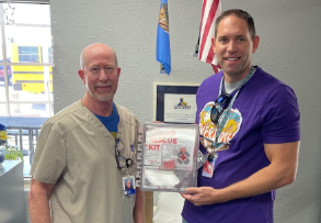 Curtis Cormell presents David Coates with an opioid rescue kit